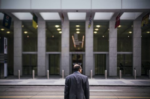 Business man standing in front of building