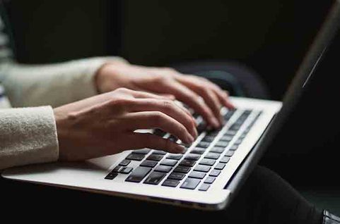 Fingers typing on computer. Photo.