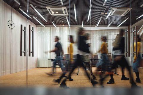 Blurry picture of people walking in an office