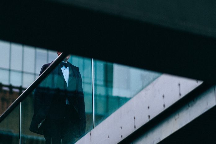 Man walking on glass bridge