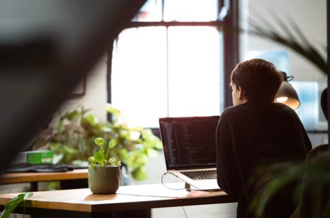 A woman sitting by her desk working