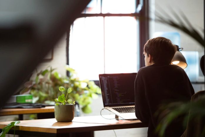 A woman sitting by her desk working